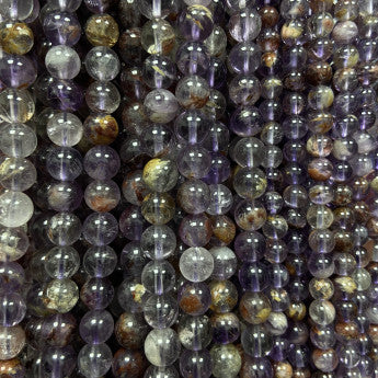 Améthyste 'super seven', perles rondes de 6 ou 8 mm, vendu : en fil de perle 38/39 cm, en bracelet de 17 à 21cm, en collier de 45 ou sautoir de 60cm. Qualité AA à AAA, superbes perles aux reflets violet, parfait !