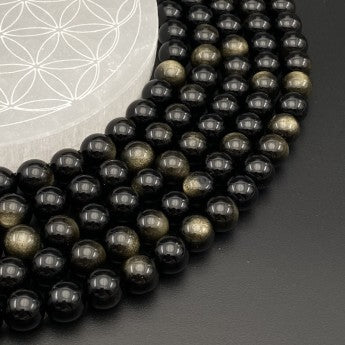 Obsidienne Dorée, perles rondes de 4, 6, 8 ou 10 mm. Vendu en fil de perle 38/39 cm, en bracelet de 17 à 21cm, en collier de 45 ou sautoir de 60cm. Qualité AA à AAA, superbes perles !